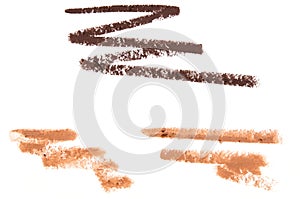 Brown smear of crushed eyeliner or acrylic paint isolated on a white background.