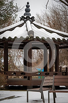 Brown snow covered pavilion near bench in Pyeongtaek-si