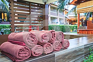 Brown spa towels roll pile for customer service in pool