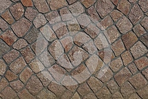 Brown stone texture of small cobblestones in the wall