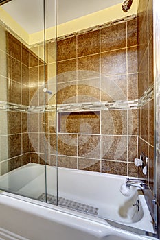 Brown stone tile shower with close up