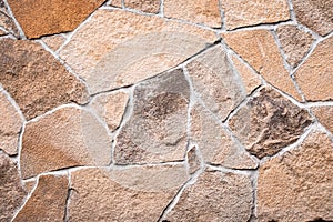 Brown stone wall texture, grunge background, abstract mosaic pattern, rocks surface, dirty rough granite. Weathered building`s