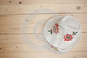 Brown straw hat On top wooden floor background / top view picture