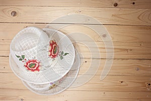 Brown straw hat On top wooden floor background / top view picture