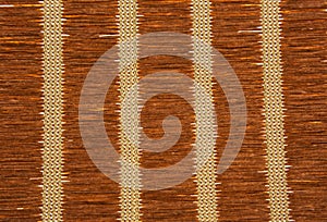 Brown straw mat texture with vertical patterns.