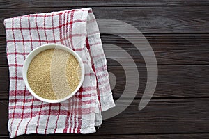 Brown sugar in bowl on brown wooden table, top view. Copy space