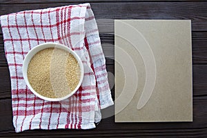 Brown sugar in bowl on brown wooden table, top view. Copy space