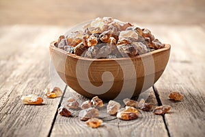 Brown sugar crystals in wooden bowl