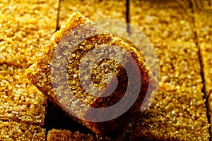 Brown sugar cube macro image. Sugar cube on top of other cubes in pack