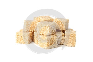 Brown sugar cubes isolated on background, close up