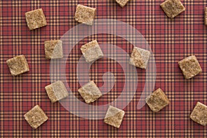 Brown sugar cubes pattern background. Top view. Diet unhealty sweet addiction concept photo