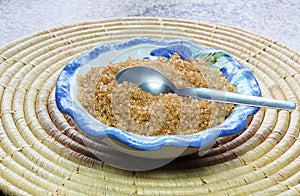 Brown sugar granules in a dish or bowl.