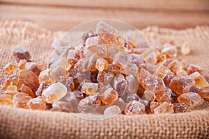 Brown sugar rock organic crystalline on a jute napkin
