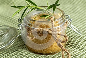 Brown sugar scrubs with herbs, natural wellness, on towel background