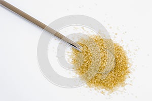 Brown sugar on silver teaspoon