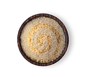 Brown sugar in wood bowl on white background. Top view