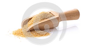 Brown sugar in wood scoon on white background