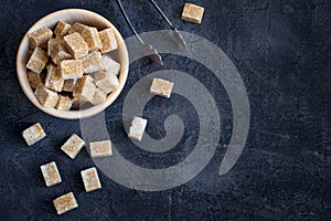 Brown sugar in a wooden bowl. Top view with copy space