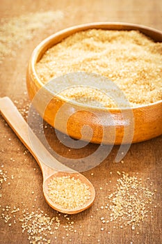 Brown sugar on wooden spoon and bowl