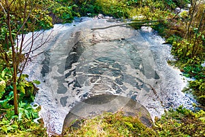 Brown swamp water flows down the pipe