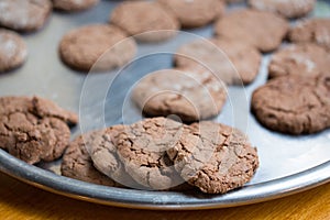 Brown tasty chocolate cookies with crackles lay at salver.