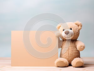 brown teddy bear with a blank sign with space for copy