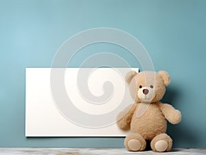 brown teddy bear with a blank sign with space for copy