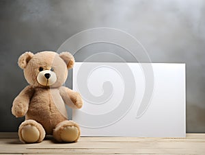 brown teddy bear with a blank sign with space for copy