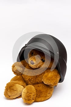 Brown teddy bear in a military helmet, on a white background, isolate. Concept: the war in Ukraine, children`s toys at war.