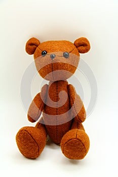 Brown teddy bear. Yellow background