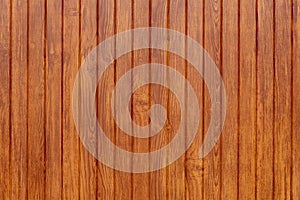 Brown textured background of vertical wooden slats.