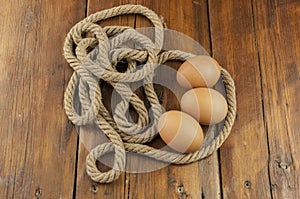 Brown three egg in a nest of twine for Happy Easter