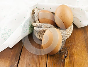 Brown three egg in a nest of twine for Happy Easter