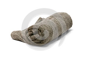 A brown towel rolled up on a white background