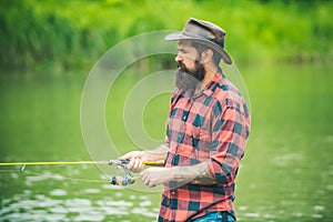 Brown trout being caught in fishing net. Fly fisherman using fly fishing rod in beautiful river. Angler. Fly rod and