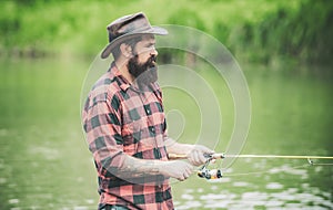 Brown trout being caught in fishing net. Fly fisherman using fly fishing rod in beautiful river. Angler. Fly rod and