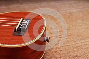 Brown Ukulele Lay on Old Brown Wood Table