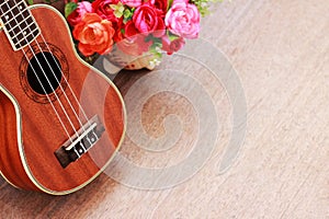 Brown Ukulele Lay on Old Brown Wood Table