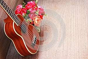 Brown Ukulele Lay on Old Brown Wood Table
