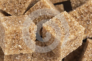 Brown unrefined cane sugar cube texture background. Macro shot refined sugar cube texture pattern