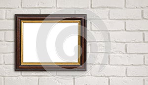 Brown vintage picture frame on white brick wall with copyspace