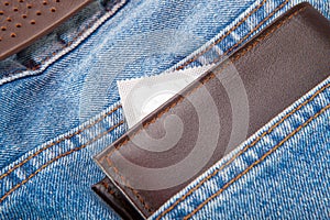 The condom and man wallet put inside a jeans pocket
