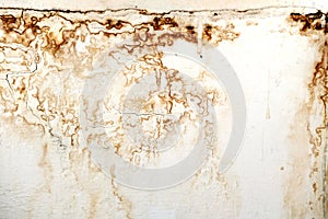 Brown water stain and bulge on plaster wall in the house.