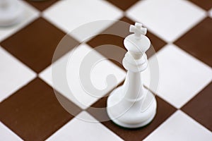 Brown and white chess board with chess pieces