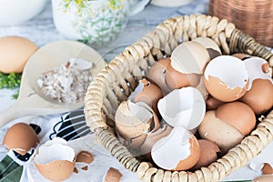 Brown and white eggshells placed in basket in home kitchen on table, eggshells stored for making natural fertilizers for growing v