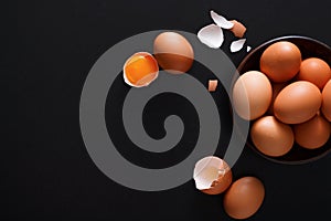 Brown and white organic eggs on wood background