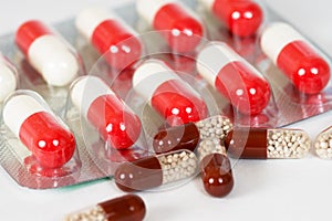 Brown and white-and-red antibiotic capsules