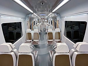 Brown white seats in the interior of a train wagon