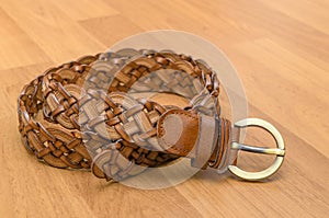 Brown women belt on wooden floor