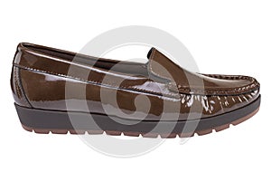 Brown women`s patent leather low-soled shoes with a tread, on a white background